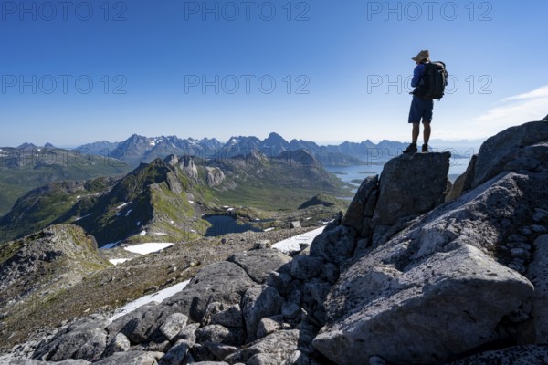 View of mountains and fjord landscape, mountain panorama, mountaineer at the summit of Rundfjellet, lake Hellskarvatnet, Svolvaer, Nordland, Norway, Europe