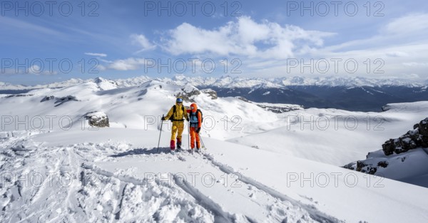 Couple, two ski tourers at the summit Wisshore with mountain panorama, snowy mountain landscape, Bernese Alps, Switzerland, Europe