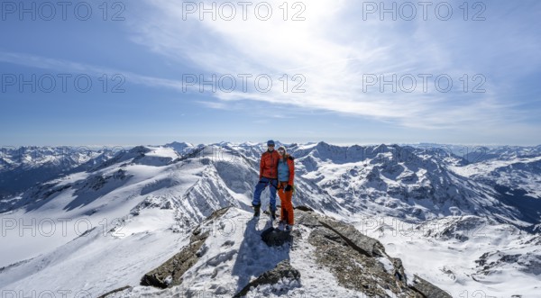 Couple, ski tourers at the summit of Monte Cevedale, mountain panorama, snow-covered mountain landscape in winter, Ortler Alps, Vinschgau Valley, Italy, Europe