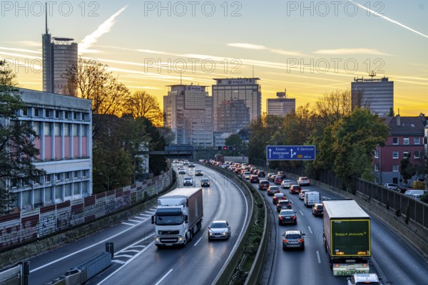 Evening traffic, partly with traffic jams, slow-moving traffic on the A40 motorway, skyline of Essen, RWE tower on the left, Evonik Group headquarters in the middle, former Postbank building on the right, Essen, North Rhine-Westphalia, Germany, Europe