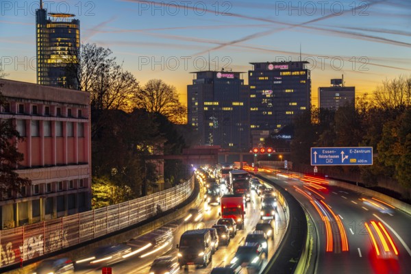 Evening traffic, partly with traffic jams, slow-moving traffic on the A40 motorway, skyline of Essen, left RWE tower, centre Evonik Group headquarters, Essen, North Rhine-Westphalia, Germany, Europe