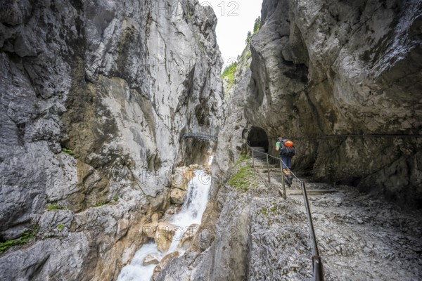 Hammersbach mountain stream in a canyon, mountaineer on a hiking trail in a gorge, Höllentalklamm, Höllental, Bavaria, Germany, Europe
