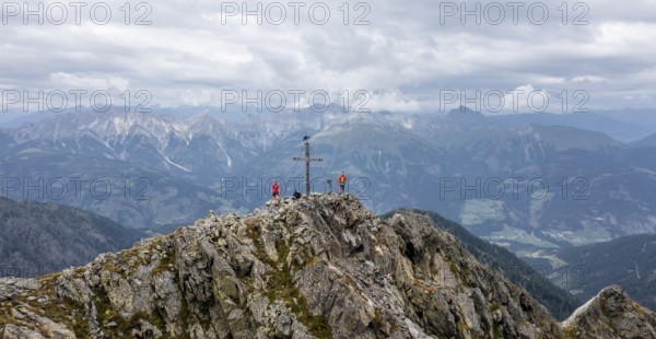 Aerial view, hiker on the Raudenspitze with summit cross, Carnic High Trail, Carnic Main Ridge, Carnic Alps, Carinthia, Austria, Europe