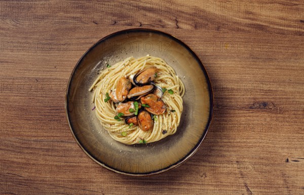 Spaghetti with mussels, without shell, pasta with peeled mussels, in carbonara sauce, micro-greens, homemade, no people