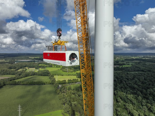 Dorsten, North Rhine-Westphalia, Germany, construction of a wind turbine, the first wind turbine of the Große Heide wind farm. A large mobile crane places the nacelle, the nacelle on the tower, Europe