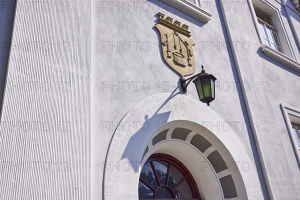 Facade of a house in the classicist style with the coat of arms of the salt boiling trade and lantern in Bad Salzuflen, Lippe district, North Rhine-Westphalia, Germany, Europe