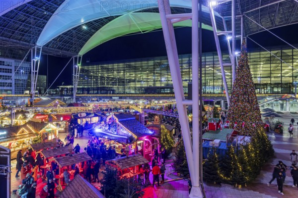 Christmas market at the airport in the evening, market stalls decorated for Christmas in front of the terminal Munich, Bavaria, Germany, Europe