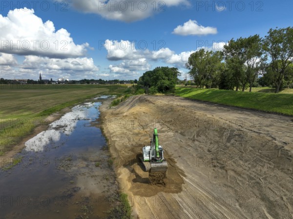 Oberhausen, North Rhine-Westphalia, Germany, renaturalisation of the Emscher in the Holtener Bruch. A new floodplain landscape for flood protection and biodiversity is being created here. The Emscher, which is currently straightened, is being given curves again and can meander through its new floodplain. The ecological reorganisation of the Emscher system consists of the construction of a central wastewater treatment system in the Ruhr area, the construction of sewers and the renaturation of the Emscher and its tributaries. Following the construction of a parallel sewer, the Emscher has been completely free of sewage since January 2022. The river was previously an open, above-ground combined sewer with rainwater and wastewater, Europe