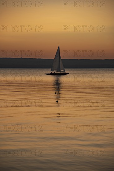 Sailing boat in the sunset with sunset on the Lake Ammer near Herrsching, Bavaria, Germany, Europe