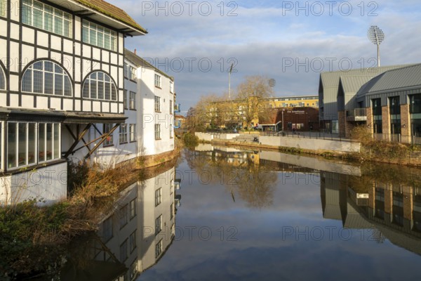 Reflection of buildings in water of River Tone, Dellers Wharf, Taunton, Somerset, England, UK