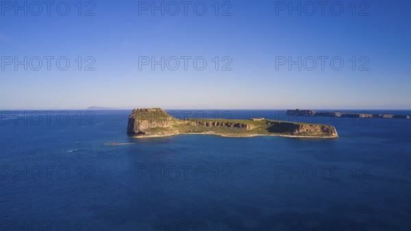 Drone shot, A deserted island in the vast blue ocean with rocky coastlines and clear skies, Venetian Sea Fortress, Gramvoussa, Gramvoussa Peninsula, Pirate Bay, Balos, Lagoon, Northwest Crete, Crete, Greek Islands, Greece, Europe