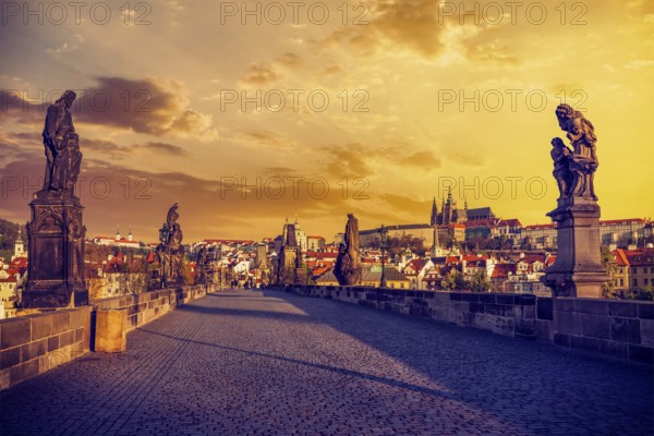 Charles bridge with statues and Prague castle in the early morning on sunrise. Prague, Czech Republic, Europe