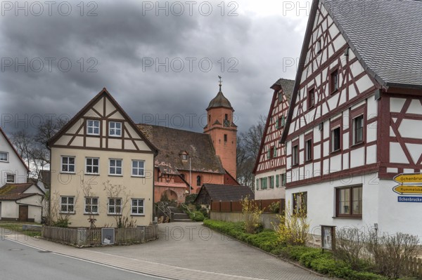 Historic half-timbered houses with the baroque church of St Vitus, built in 1464, Altenthann. Middle Franconia, Bavaria, Germany, Europe