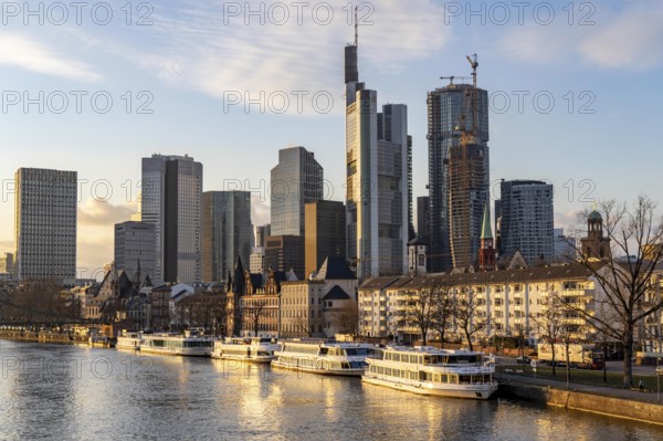 Skyline of the city centre of Frankfurt am Main, river Main, excursion boats at the Mainkai, dusk, Hesse, Germany, Europe