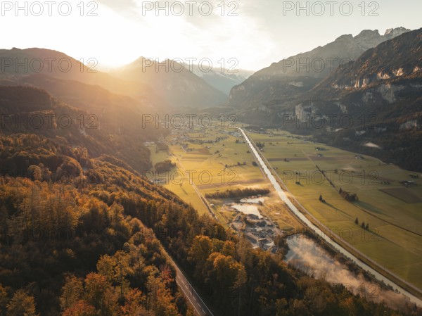 View of a wide valley at dusk with roads, fields and mountains, Meiringen, Switzerland, Europe