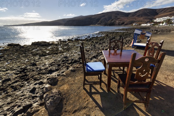 Wooden table and four chairs, fish restaurant on the beach, Playa Quemada, Yaiza, Lanzarote, Spain, Europe