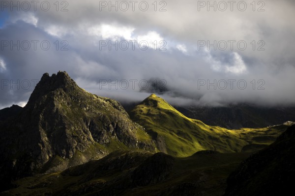 Grassy mountains with light mood and threatening clouds, Tschagguns, Rätikon, Montafon, Vorarlberg, Austria, Europe