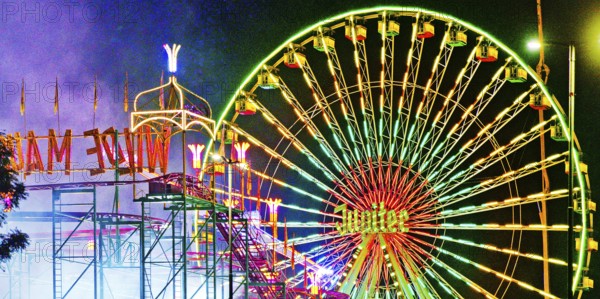 Cranger Kirmes with colourfully illuminated fairground rides and the Ferris wheel at night, Herne, Ruhr area, North Rhine-Westphalia, Germany, Europe