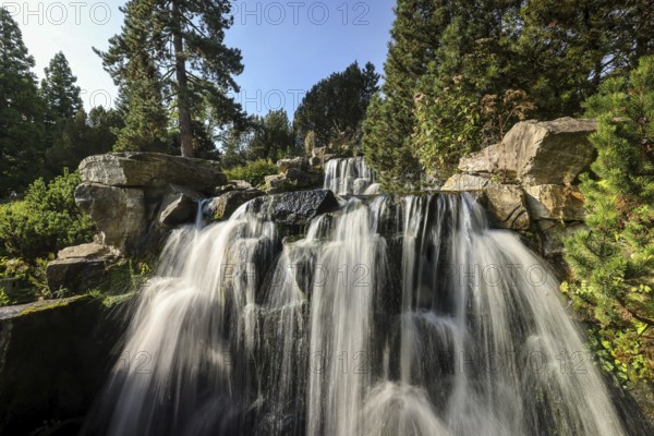Essen, North Rhine-Westphalia, Germany - Alpinum with waterfall, Grugapark, a park in Essen, emerged from the first Great Ruhrland Horticultural Exhibition in 1929, was the park grounds of the 1965 Federal Garden Show