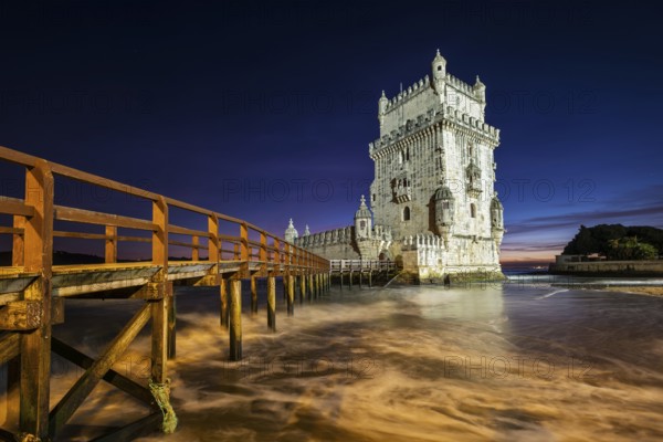 Belem Tower or Tower of St Vincent, famous tourist landmark of Lisboa and tourism attraction, on the bank of the Tagus River (Tejo) after sunset in dusk twilight with dramatic sky. Lisbon, Portugal, Europe