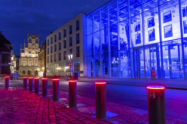 Historic old town, facade of the historic town hall, blue illuminated building of the Münster district government, illuminated barrier, bollards, in Münster, North Rhine-Westphalia, Germany, Europe