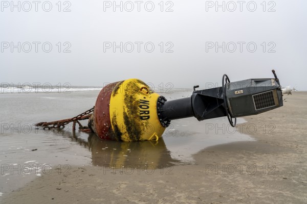 Washed up buoy, sea mark, detached in a storm, originally off the island of Norderney in the North Sea, Wadden Sea World Heritage Site, North Sea island of Spiekeroog, East Frisian North Sea coast, at low tide
