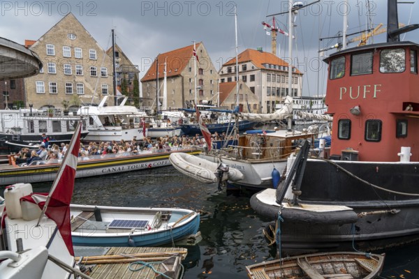 Ships and boats on Christianshavns Kanal, old district, at the same time very lively and hip neighbourhood, crossed by many canals, with shops, pubs, living space, Copenhagen, Denmark, Europe