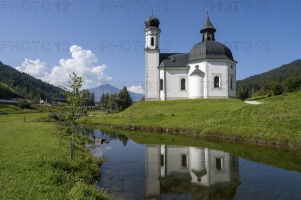 Seekirchl with reflection, Heiligkreuzkirche, view from the parish hill, Seefeld, Tyrol, Austria, Europe
