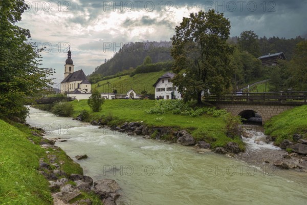 Parish church of St Sebastian, bridge, stream, rainy weather, Ramsauer Ache, Ramsau, Berchtesgadener Land, Upper Bavaria, Bavaria