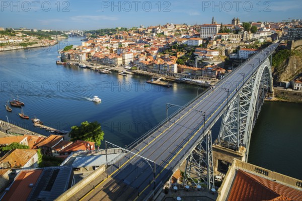 View of Porto city and Douro river and Dom Luis bridge I from famous tourist viewpoint Miradouro da Serra do Pilar on sunset. Porto, Vila Nova de Gaia, Portugal, Europe