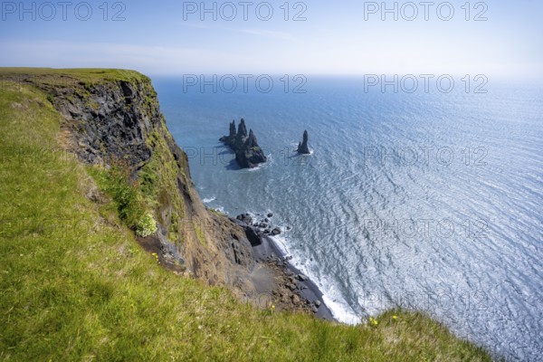Steep coast, view from steep cliff to the rocks Reynisdrangar in the water, at Reynisfjara beach, Vik, South Iceland, Iceland, Europe