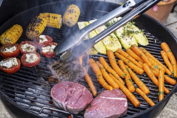 Whether vegetarian or with meat: barbecues are on trend. Vegetables such as carrots, tomatoes and courgettes as well as steaks on a kettle grill. Germany