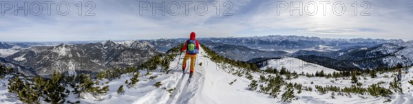 Ski tourer at the summit of Simetsberg, panorama with Walchensee, mountain panorama, Estergebirge, Bavarian Prealps, Bavaria Germany