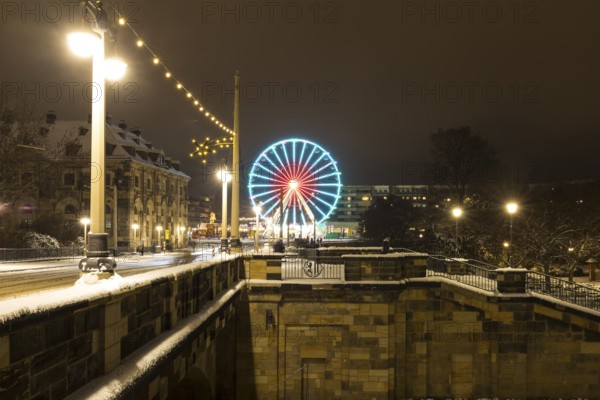 Christmas illumination on the Augustus Bridge in the snow with log cabin, Ferris wheel and steps, Dresden, Saxony, Germany, Europe