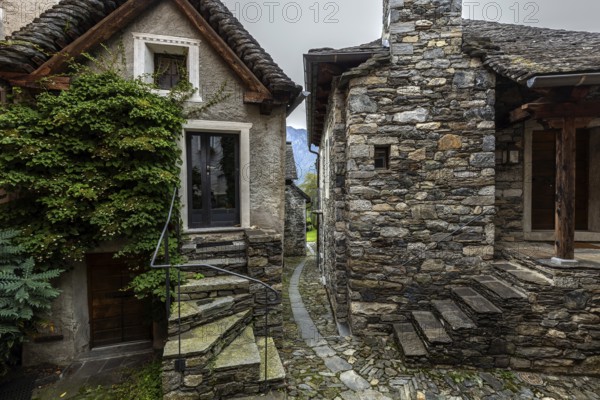Typical Ticino stone houses in a narrow alley in the mountain village of Bordei, Centovalli, Canton Ticino, Switzerland, Europe