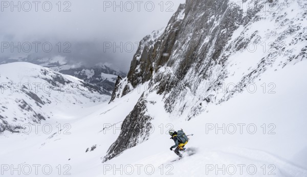 Ski tourer on a steep mountain slope, Snowy mountain landscape, Bernese Alps, Bernese Oberland, Switzerland, Europe