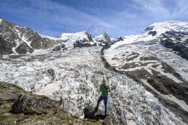 Mountaineers on the glacier, High alpine glaciated mountain landscape, La Jonction, Glacier des Bossons meets Glacier de Taconnaz, Summit of Mont Maudit and Mont Blanc, Chamonix, Haute-Savoie, France, Europe