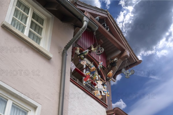 Historic roof lift bay window decorated with colourful figures, Villingen-Schwenningen, Baden-Württemberg, Germany, Europe