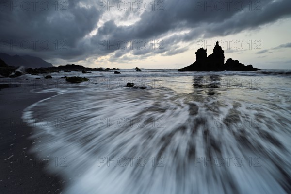 Dramatic clouds with rock formation at rising tide at the beach of Playa de Benijo, Tenerife, Canary Island, Spain, Europe