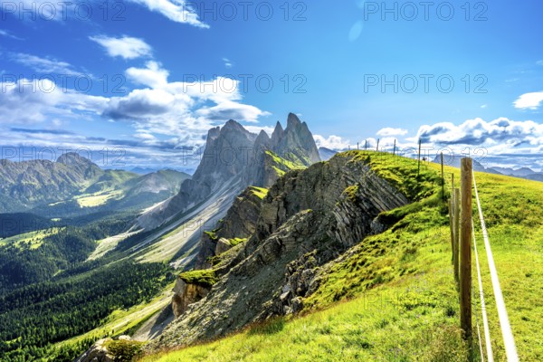 Majestic peaks of seceda rise above lush green valleys and meadows in the italian dolomites, a breathtaking summer vista