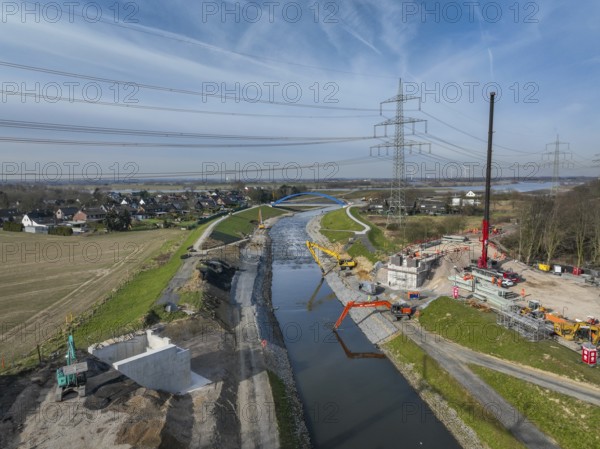 Dinslaken, Voerde, North Rhine-Westphalia, Germany - New Emscher estuary into the Rhine. New construction of the railway bridge and restoration of the dykes after dyke erosion during the 2023 flood. Renaturalisation of the Emscher. Flood protection through land expansion. The mouth of the Emscher into the Rhine was moved almost 500 metres north from Dinslaken to Voerde. Fish can now swim up the new Emscher from the Rhine through a newly created floodplain area without any barriers. Following the construction of a parallel sewer, the Emscher has been completely free of sewage since January 2022. The river was previously an open, above-ground combined sewer with rainwater and wastewater