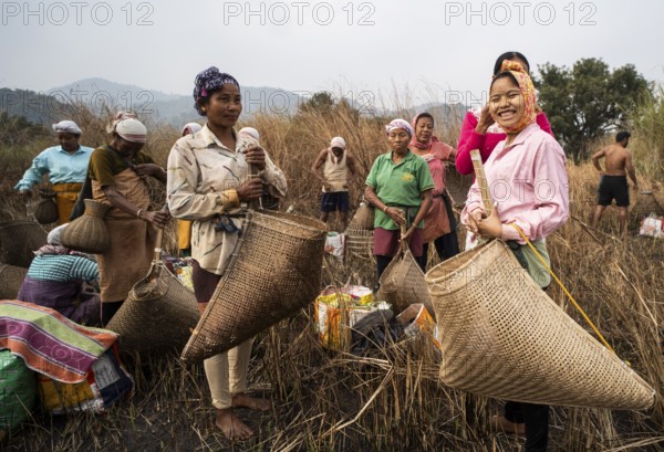 Villagers participate in a community fishing event on the occasion of the Bhogali Bihu festival at Panbari village in Assam on 13 January 2025. Magh Bihu, also known as Bhogali Bihu, is one of the most vibrant festivals celebrated in Assam and other parts of Northeast India