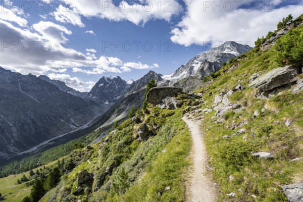 Hiking trail through picturesque mountain landscape near Arolla, behind mountain peak Mont Collon, Valais, Western Alps Switzerland