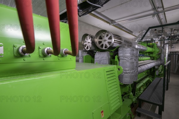 Biogas plant, gas-powered engine for electricity production, generator, in combined heat and power plant, the gas is produced from various biomass, including waste from the food industry, the electricity is produced in combined heat and power plants with the biogas produced and fed into the grid, the heat is sent to 70 households via a local heating network, part of the gas is processed and fed into the Thyssengas gas network, Anröchte, North Rhine-Westphalia, Germany, Europe