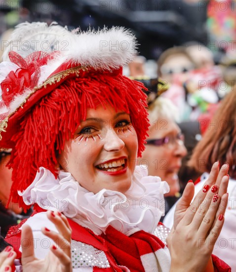 Colourfully costumed carnivalists celebrate carnival in Cologne, on Weiberfastnacht the street carnival is traditionally opened on the Alter Markt, which then reaches its climax on Rosenmontag, Cologne, Rhineland, North Rhine-Westphalia, Germany, Europe