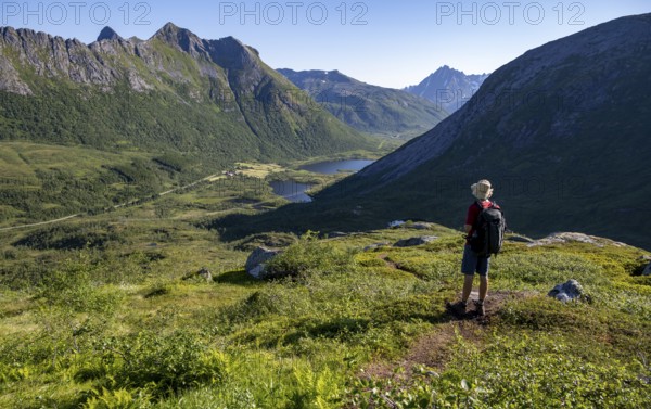 Mountaineers on a hiking trail to the summit of Rundfjellet, mountain landscape and valley with lakes, near Austnesfjord, Svolvaer, Nordland, Norway, Europe