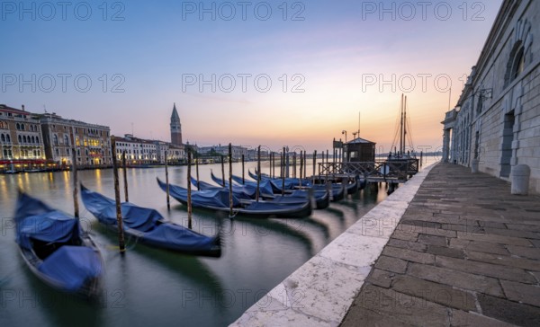 Venetian gondolas, boat dock at the customs office on the Grand Canal, Gondola Traghetto Dogana, Campanile behind, long exposure at sunrise, Venice, Veneto, Italy, Europe