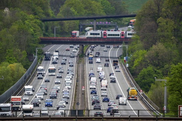 Local train S-Bahn, Regiobahn, S28, crossing the motorway A3, traffic on 8 lanes, incl. the temporarily released hard shoulder, behind the motorway junction Hilden, view in north direction, near Erkrath, North Rhine-Westphalia, Germany, Europe