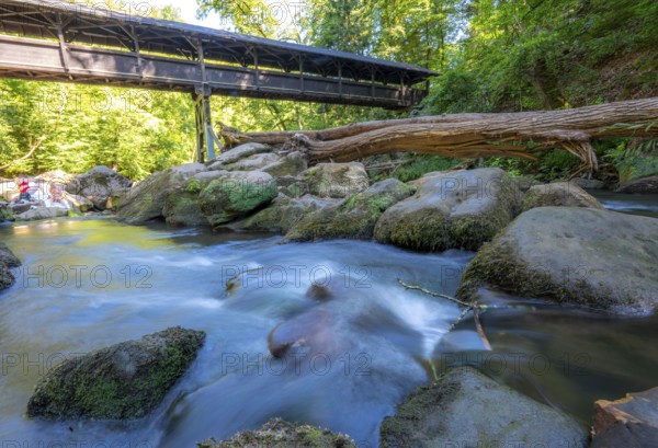 The Irrel Waterfalls, rapids in the lower reaches of the Prüm, covered wooden bridge for hikers, between Prümzurlay and Irrel, in the Eifel district of Bitburg-Prüm, Rhineland-Palatinate. Germany
