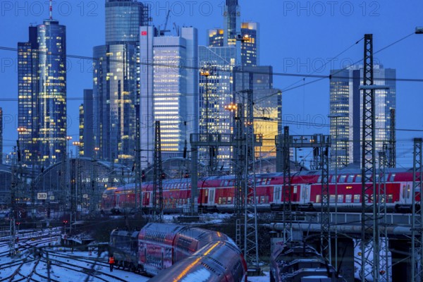 Railway tracks in front of the main railway station in Frankfurt am Main, skyline of skyscrapers in the Cit, winter, snow, dusk, Hesse, North Rhine-Westphalia